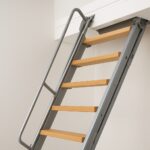A modern loft ladder with wooden steps leading up to an open loft space.